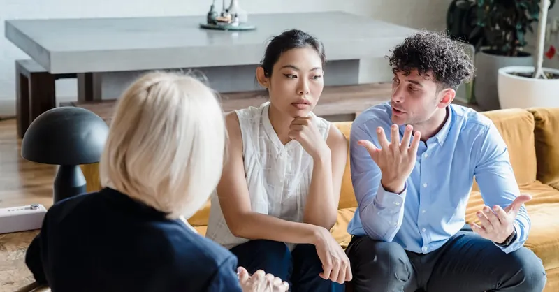 Couple discussing issues with a therapist during a counseling session.