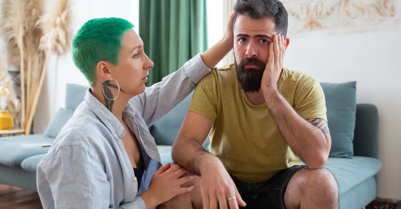A couple shares an emotional exchange at home, offering comfort and support.