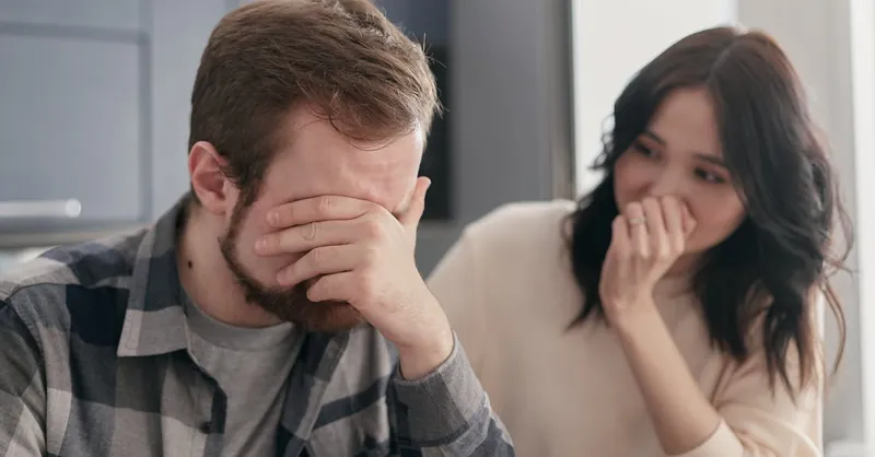 A distraught couple indoors, showing stress and concern, fostering empathy.