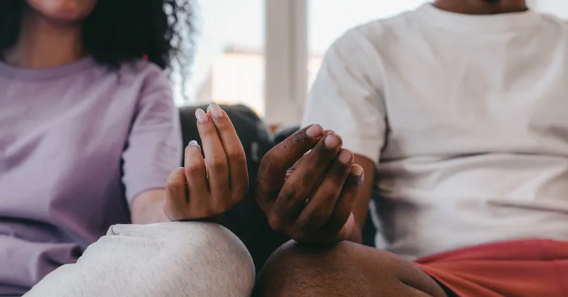 Couple practicing meditation at home, focusing on mindfulness and relaxation.