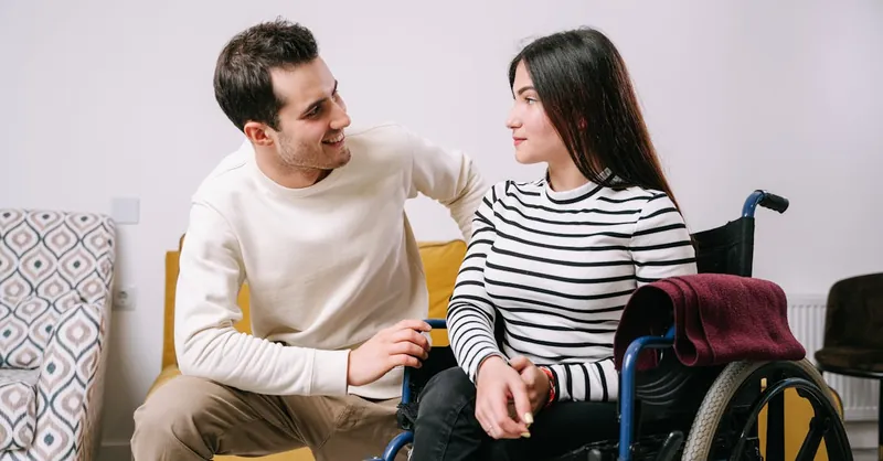 A loving couple sharing a heartfelt moment, showcasing support and connection despite physical challenges.