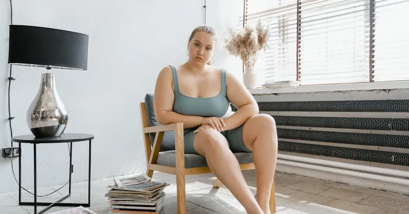 Confident plus size woman in a serene setting, embracing self-esteem and body positivity.