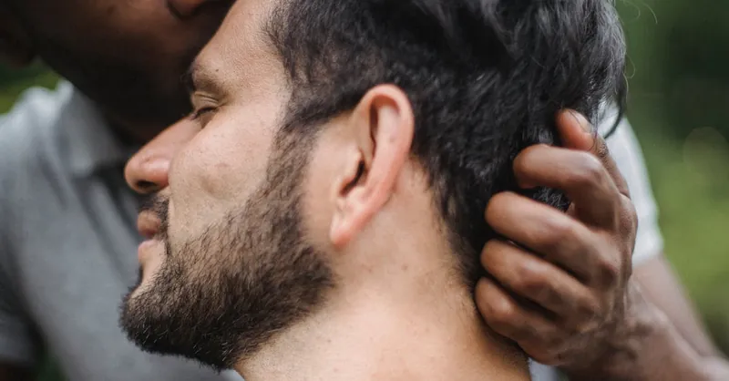 Close-up of a couple sharing an intimate moment outdoors, showcasing love and connection.