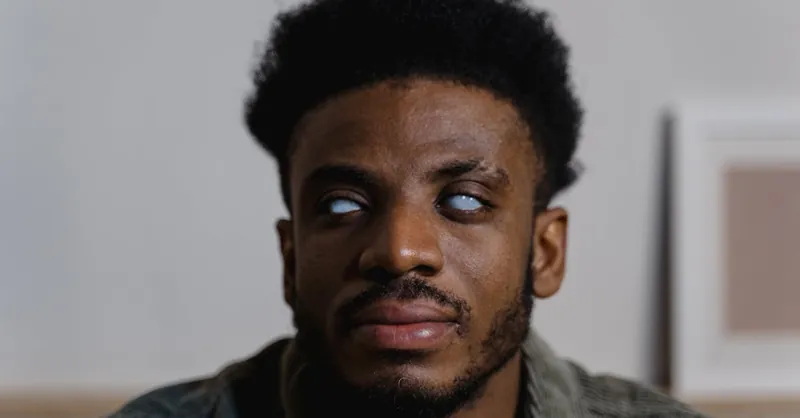 Close-up of a man with visual impairment demonstrating independence and strength.