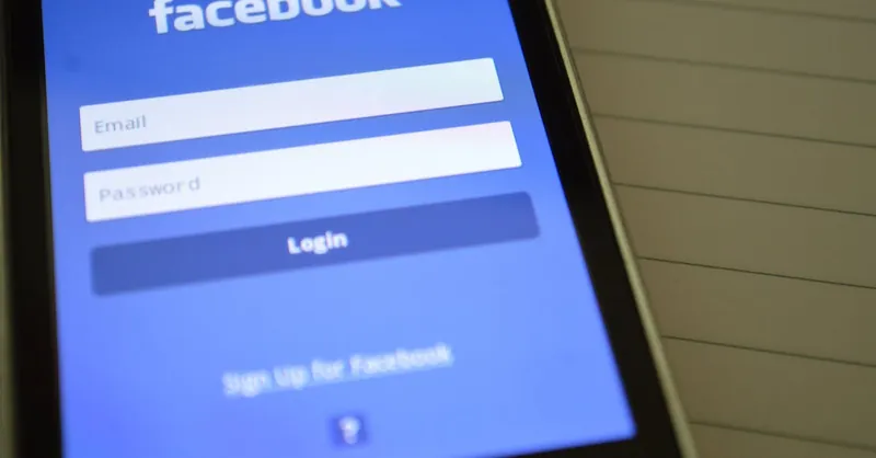 Mobile phone with Facebook login screen, highlighting digital connectivity and social media use.