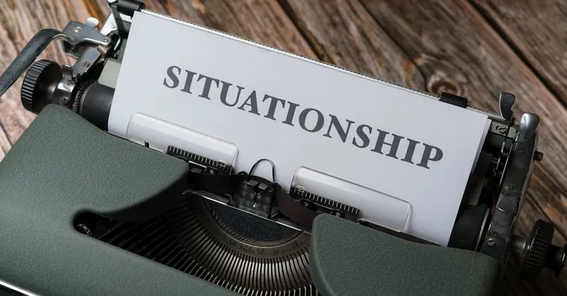 Close-up of a vintage typewriter with "Situationship" typed on paper, symbolizing modern dating concepts.